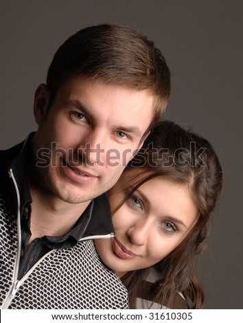 Portrait young nice  guy and  girl on  dark background