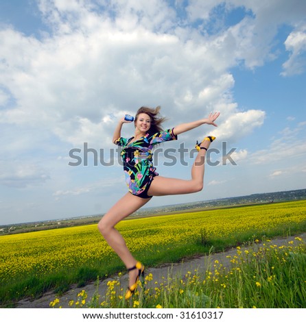 young woman highly has jumped up above  field,  bright sunny day