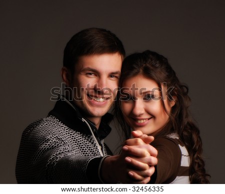 Pair nice young people on  dark background,  portrait