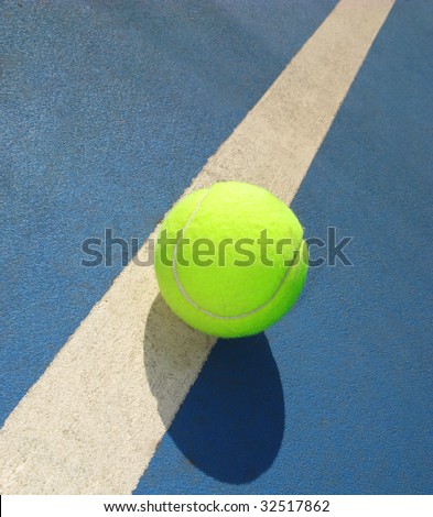 White line of tennis court and ball, sunny day, shadow