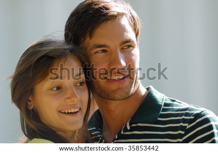 Cheerful pair young people on  light background, summer day