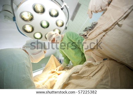 surgical operation on the vessels of hand, surgeons work in an operating-room