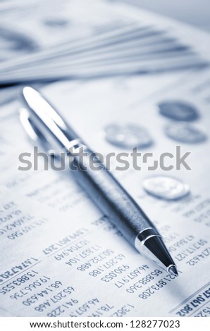 A pen and US currency on the paper of statement