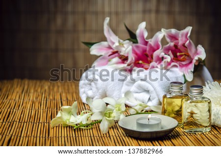 Towels, oil, candle, flowers for spa treatment