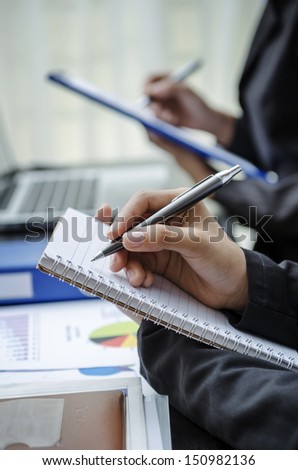 Closeup of people hands taking note