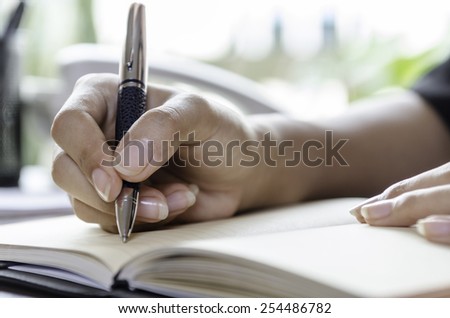 closeup of woman hands taking note