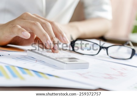 Woman calculating the documents in an office