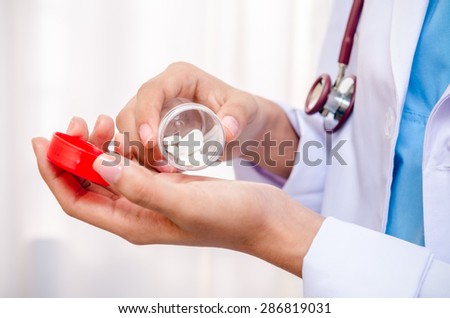 doctor taking medicine on her hand to check