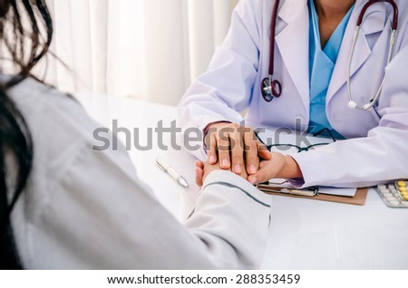close up of doctor consulting and cheering patient
