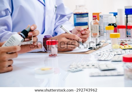 two pharmacists preparing prescription and medicine box