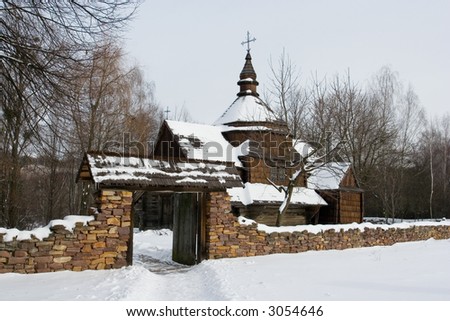 An old wooden church covered with snow