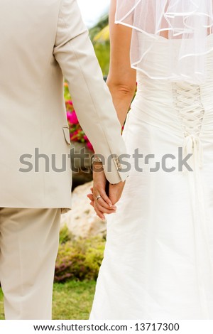 stock photo Couple holding hands with wedding rings just married 
