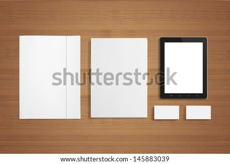 Blank Stationery set on wooden background with soft shadows. Consist of Business cards, A4 letterheads, Folder, Tablet PC.