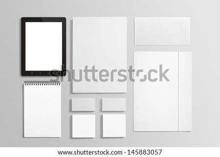 Blank Stationery set isolated on grey with soft shadows. Consist of Business cards, A4 letterheads, Folder, Tablet PC, envelopes and notebook.