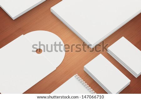 Blank Stationery isolated on wooden close view. Consist of Business cards, A4 letterheads, note, cd disk and notebook.