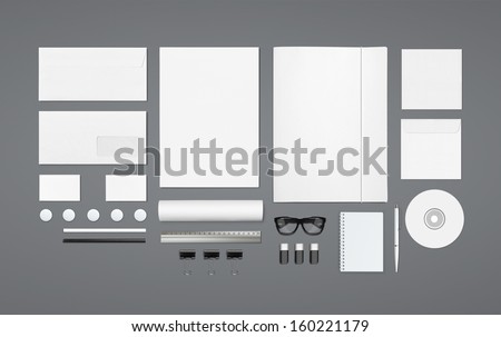 Blank Stationery Corporate ID set on wooden background with soft shadows. Consist of Business cards, A4 letterheads, Folder, Tablet PC, envelopes, tube, phones, disk and notebook.