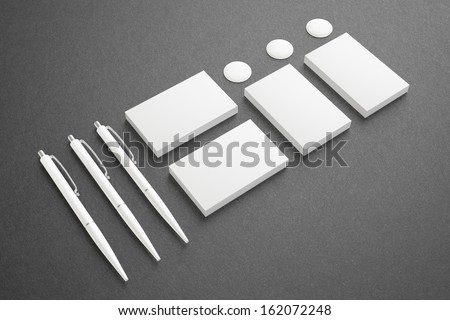 Blank Stationery Corporate ID set ondark background. Consist of Business cards and pens.