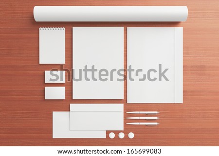 Blank Stationery / Corporate ID Set on wooden background. Consist of Business cards, folder, envelopes, a4 letterheads, pens,folder; tube
