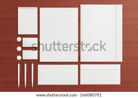 Blank Stationery / Corporate ID Set on wooden background. Consist of Business cards, Folder, envelopes, a4 letterheads, pens,folder.