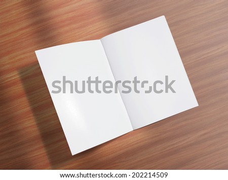 Blank opened brochure photo on wooden background to replace your design