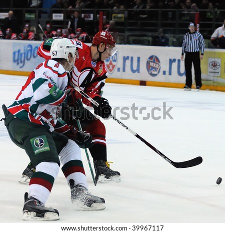 YEKATERINBURG, RUSSIA - OCT 14: Brothers Dm.Kazionov (AK Bars, left) and D.Kazionov (Automobilist) competes during the KHL game held in Yekaterinburg on Oct 14 2009. AK Bars beat Automobilist 3:1