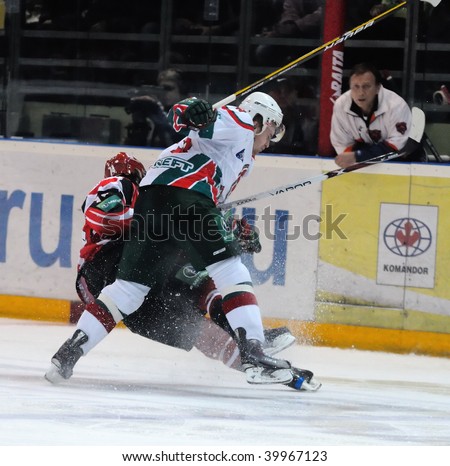 YEKATERINBURG, RUSSIA - OCT 14: AK Bars player, N.Kappanen uses body-check against I.Khomutov (Automobilist) during the KHL game held in Yekaterinburg on Oct 14 2009. AK Bars beat Automobilist, 3:1