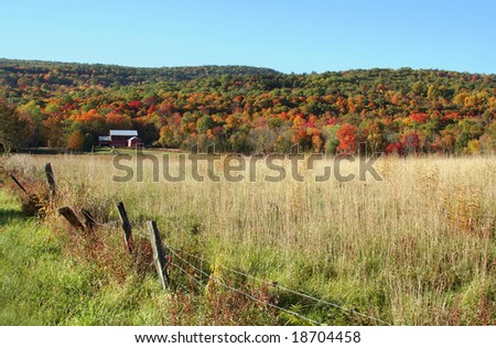 Red barn, fall foliage and mountains in New England Countryside
