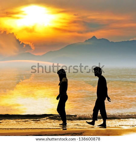 couple walk together on the beach in sunset , HuaHin ,Thailand
