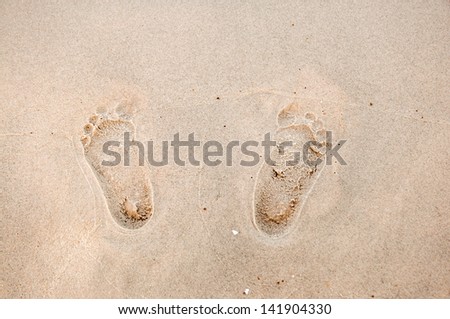 Footprints in sand at the Beach