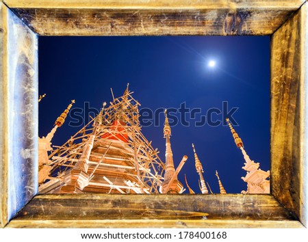 temple at night in old wooden picture frame