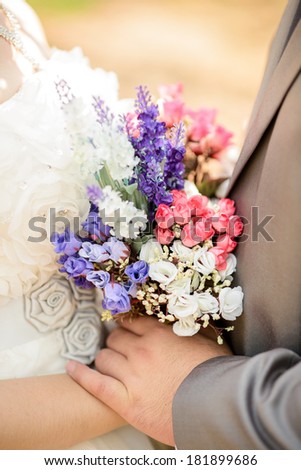 Bride and groom's hands  in vintage , flowers bouquet