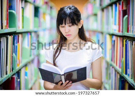 A portrait of  Asian college student  studying in the library , thai student