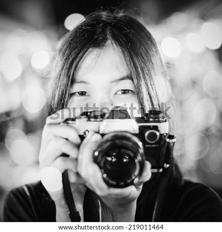 portrait asian girl hold vintage photo camera on vintage background
