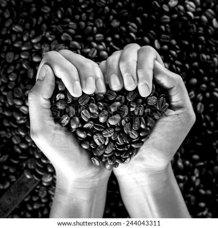 coffee heart shape held in woman hands , black and white picture