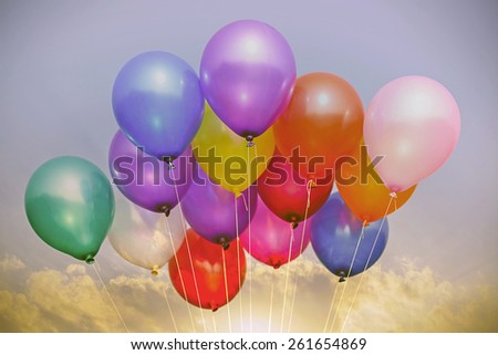 colorful balloons in blue sky and clouds , vintage background