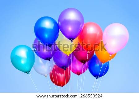 colorful balloons in blue sky and clouds