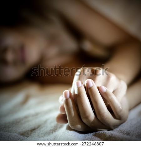 Sad woman is lying in bed at night , dark feeling