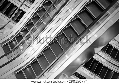 The multiple steps and directions of an escalator in the modern shopping mall , black and white background