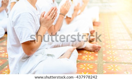 Group of peaceful people meditating in temple  at sunset , Chiang mai ,Thailand
