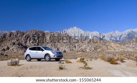A Suv At Rocky Desert In Eastern Sierra, California.