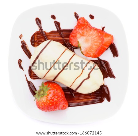 Arrangement of White Chocolate Eclair with Chocolate Sauce and Sliced Strawberry on White Plate closeup on white background. Top View