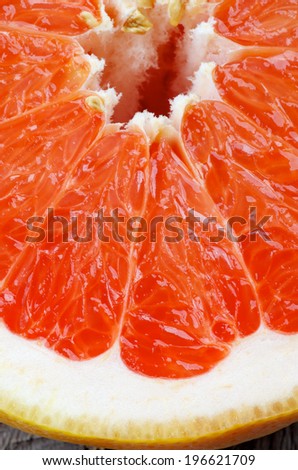 Background of Fresh Juicy Red Grapefruit Slice Cross Section closeup