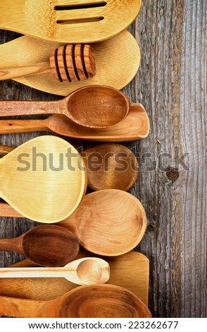 Frame of Various Wooden Spoons and Cooking Utensils isolated on Rustic Wooden background