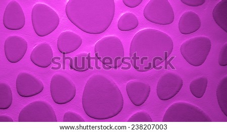 Background of Purple Droplet Shaped Stone on Cement Wall closeup