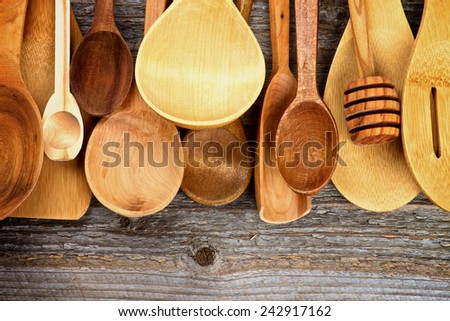 Horizontal Frame of Various Wooden Spoons and Cooking Utensils isolated on Rustic Wooden background