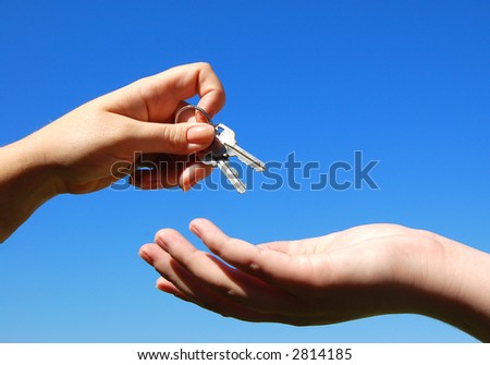 handing keys from one person to another symbolizing success or partnership