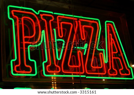 Neon pizza sign on the streets of New York