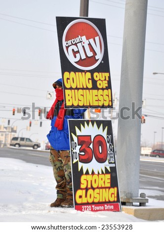 Dayton Ohio: January 19 2009. Employee carrying store closing sign at Circuit City. All stores of the second leading electronics retailer are closing. Relates to current economic times