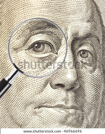 Ben Franklin dollar image with eye enlarged by a magnifying glass