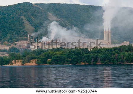 Smoking chimneys of the plant on the river